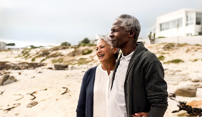 senior couple, home in background